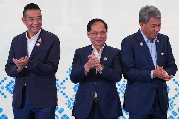 From left to right, Thailand's Minister of Foreign Affairs Maris Sangiampongsa, Vietnam's Deputy Prime Minister and Minister of Foreign Affairs Bui Thanh Son and Malaysia's Minister of Foreign Affairs Mohamad Hasan clap after a group photo session during the ASEAN Foreign Ministers' Retreat (AMM) in Langkawi Island, Malaysia, on Sunday, Jan. 19, 2025. AP Photo/Azneal Ishak, Pool)