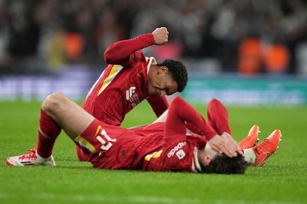 Liverpool's Dominik Szoboszlai and Liverpool's Curtis Jones on the pitch disappointed after losing the EFL Cup final soccer match between Liverpool and Newcastle at Wembley Stadium in London, Sunday, March 16, 2025. (AP Photo/Alastair Grant)