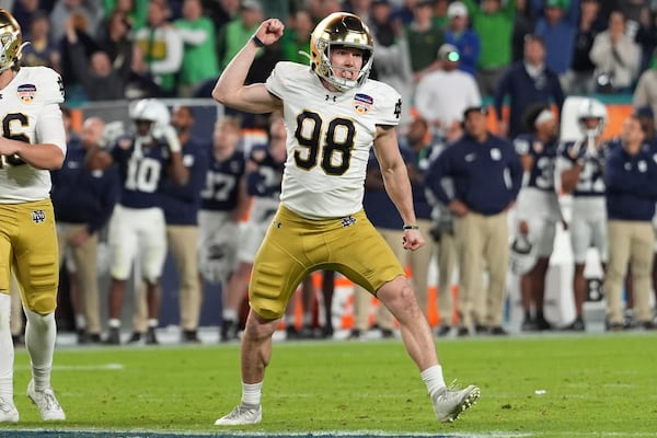 Notre Dame place kicker Mitch Jeter (98) celebrates after kicking the game winning field goal during the second half of the Orange Bowl College Football Playoff semifinal game against Penn State, Thursday, Jan. 9, 2025, in Miami Gardens, Fla. (AP Photo/Rebecca Blackwell)