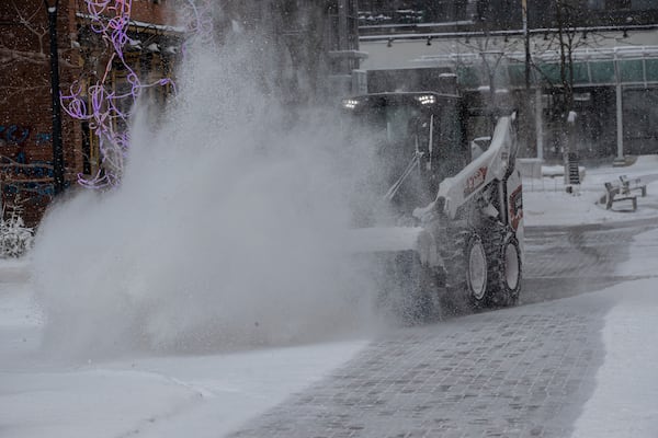 City workers clear snow from the pedestrian mall in Iowa City, Iowa on Wednesday, Feb. 12, 2025. (Nick Rohlman/The Gazette)