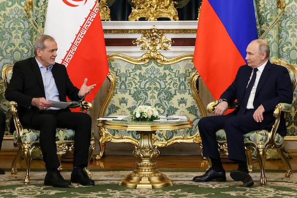 Russian President Vladimir Putin, right, and Iranian President Masoud Pezeshkian talk to each other during their meeting at the Kremlin in Moscow, Russia, Friday, Jan. 17, 2025. (Vyacheslav Prokofyev, Sputnik, Kremlin Pool Photo via AP)