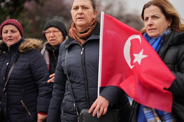 Women stand in protest outside the City Hall following the arrest of Istanbul Mayor Ekrem Imamoglu in Istanbul, Turkey, Wednesday, March 19, 2025. (AP Photo/Francisco Seco)