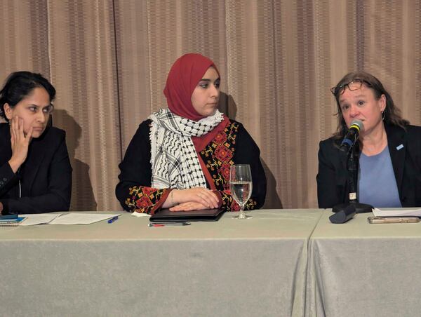 Mapheze Saleh, center, wife of arrested and detained Georgetown University scholar Badar Khan Suri, listens as senior immigrant rights attorney at ACLU Virginia Eden Heilman, right, speaks during a press conference about her husband's release following his hearing at Federal District Court for the Eastern District of Virginia, in Alexandria, Va., Thursday, May 14, 2025 (AP Photo/Nathan Ellgren)