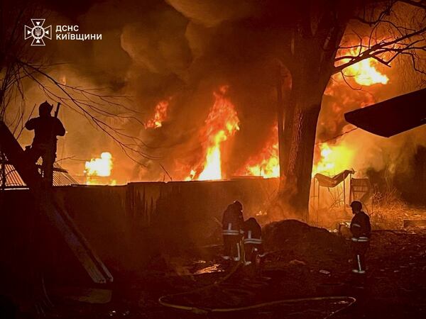 In this photo provided by the Ukrainian Emergency Service, firefighters put out the fire following a Russian attack in near Kyiv, Ukraine, Sunday, March 23, 2025. (Ukrainian Emergency Service via AP)