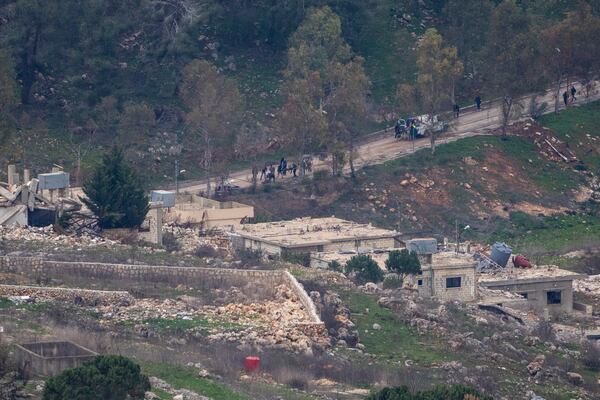 Lebanese emergency services evacuate people wounded by gunshots in a southern Lebanese village, where Israeli soldiers continue to operate despite the ceasefire, as seen from northern Israel Sunday, Jan. 26, 2025. (AP Photo/Ariel Schalit)