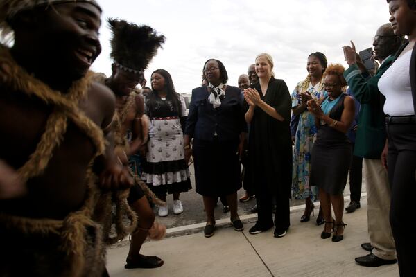 Newly elected International Olympic Committee IOC President Kirsty Coventry, center, is welcomed at the Robert Gabriel Mugabe airport in Harare, Zimbabwe, Sunday, March 23, 2025. (AP Photo/Aaron Ufumeli)