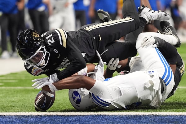 BYU quarterback Gerry Bohanon, front bottom, is stopped by Colorado safety Shilo Sanders (21) just short of the goal line during the first half of the Alamo Bowl NCAA college football game, Saturday, Dec. 28, 2024, in San Antonio. (AP Photo/Eric Gay)