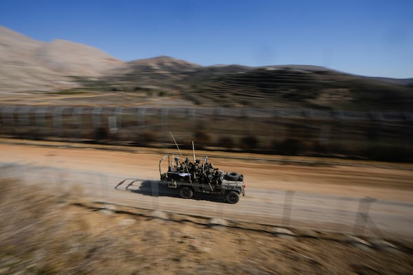 Israeli soldiers stand on an armoured vehicle after crossing the security fence along the so-called Alpha Line that separates the Israeli-controlled Golan Heights from Syria, in the town of Majdal Shams, Tuesday, Dec. 17, 2024. (AP Photo/Matias Delacroix)