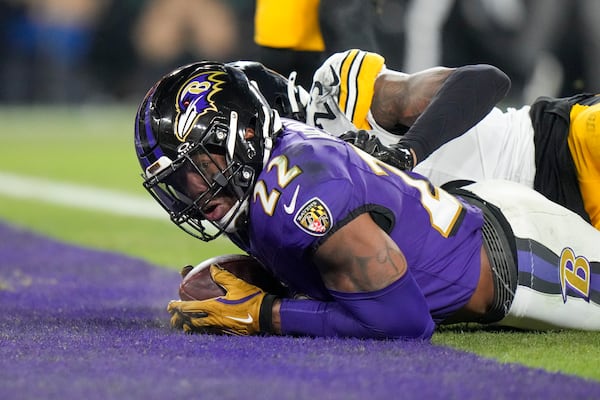 Baltimore Ravens running back Derrick Henry, front, looks on after scoring a touchdown in front of Pittsburgh Steelers safety DeShon Elliott during the first half of an NFL wild-card playoff football game, Saturday, Jan. 11, 2025, in Baltimore. (AP Photo/Stephanie Scarbrough)