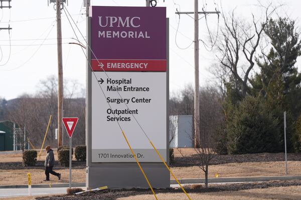 FILE - A person walks by the entrance of UPMC Memorial Hospital in York, Pa., Feb. 22, 2025. (AP Photo/Matt Rourke, File)