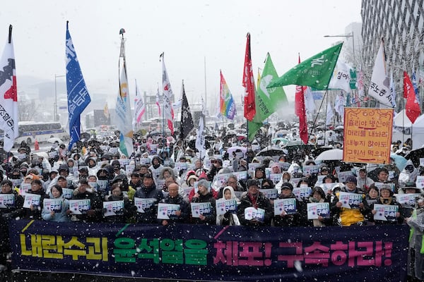 Protesters stage a rally demanding the arrest of impeached South Korean President Yoon Suk Yeol near the presidential residence in Seoul, South Korea, Sunday, Jan. 5, 2025. The letters read "Arrest Yoon Suk Yeol." (AP Photo/Ahn Young-joon)