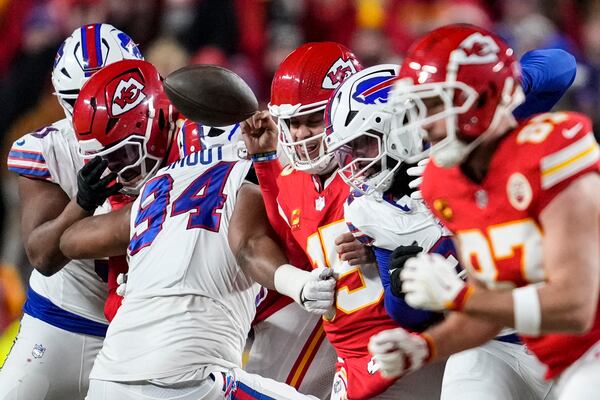 Buffalo Bills defensive end Dawuane Smoot (94) hits Kansas City Chiefs quarterback Patrick Mahomes (15) during the first half of the AFC Championship NFL football game, Sunday, Jan. 26, 2025, in Kansas City, Mo. (AP Photo/Ashley Landis)