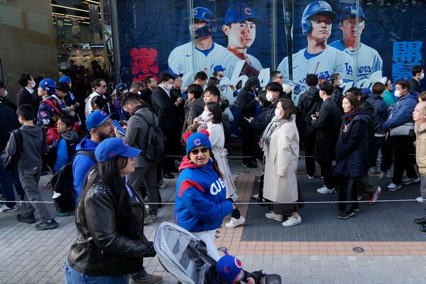 Chicago Cubs' fans walk around the Tokyo Dome ahed of an MLB Tokyo Series baseball game between the Los Angeles Dodgers and the Chicago Cubs, in Tokyo, Tuesday, March 18, 2025. (AP Photo/Shuji Kajiyama)