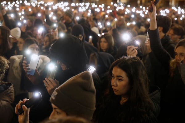 People light their mobile phones during a protest for the victims of a massive nightclub fire in the town of Kocani, in Skopje, North Macedonia, Tuesday, March 18, 2025. (AP Photo/Boris Grdanoski)