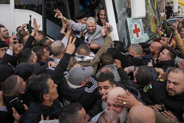 Palestinian prisoners as greeted as they exit a Red Cross bus after being released from Israeli prison following a ceasefire agreement between Israel and Hamas, in the West Bank city of Ramallah, Saturday Feb. 1, 2025. (AP Photo/Mahmoud Illean)