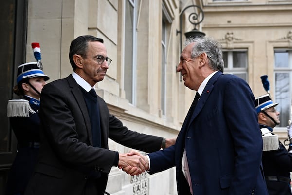 French Minister of the Interior Bruno Retailleau, left, welcomes French Prime Minister Francois Bayrou to attend a meeting at the Interior Ministry in Paris, Monday Dec. 23, 2024, following the cyclone Chido's passage over the French Indian Ocean territory of Mayotte. Hard-right Bruno Retailleau stays on as interior minister, with responsibility for France's security and migration policy. (Julien de Rosa, Pool via AP)