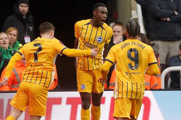 Brighton and Hove Albion's Danny Welbeck, centre, celebrates with teammates after scoring their side's second goal during the FA Cup fifth round match between Newcastle United and Brighton and Hove Albion at St James' Park, Newcastle, England, Sunday, March 2, 2025. (Owen Humphreys/PA via AP)