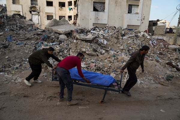 A body of a Palestinian killed in an Israeli army airstrikes is brought to Shifa Hospital in Gaza City, Tuesday, March 18, 2025. (AP Photo/Abdel Kareem Hana)