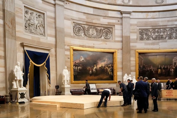 Workers build a stage in the U.S. Capitol Rotunda in Washington Friday, Jan. 17, 2025, for the 60th Presidential Inauguration which was moved indoors because of cold temperatures expected on Jan 20. (AP Photo/Morry Gash)