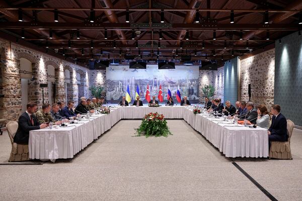 In this handout photo released by Turkish Foreign Ministry, Turkish Foreign Minister Hakan Fidan, center, chairs a meeting between delegations from Russia, right, and Ukraine, left, at Dolmabahce palace in Istanbul, Turkey, Friday, May 16, 2025. (Murat Gok/Turkish Foreign Ministry via AP)