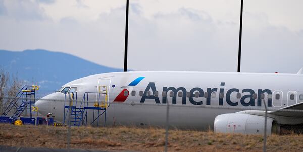 An American Airlines jetliner that caught fire after landing Thursday at Denver International Airport sits near a hangar at the airport Friday, March 14, 2025, in Denver. (AP Photo/David Zalubowski)