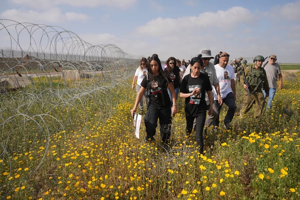 Einav Zangauker, mother Matan, who is held hostage by Hamas in the Gaza Strip, and other relatives of hostages attempt to approach the Gaza border, escorted by Israeli soldiers, calling for their release and expressing concerns that the resumption of fighting in Gaza puts their loved ones at risk, in southern Israel, Tuesday, March 18, 2025. (AP Photo/Ohad Zwigenberg)