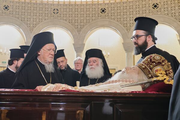 Ecumenical Patriarch Bartholomew I, left, the spiritual leader of the world's Orthodox Christians, pays his respects to the late Archbishop Anastasios of Tirana, Durres and All Albania during his funeral, inside the Cathedral of the Resurrection of Christ, in Tirana, Albania, Thursday, Jan. 30, 2025. (AP Photo/Vlasov Sulaj)