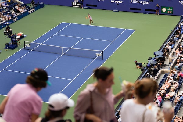 FILE - Spectators move to their seats during play between Varvara Gracheva, of France, and Coco Gauff, of the United States, during the first round of the U.S. Open tennis championships, Monday, Aug. 26, 2024, in New York. (AP Photo/Matt Rourke, File)