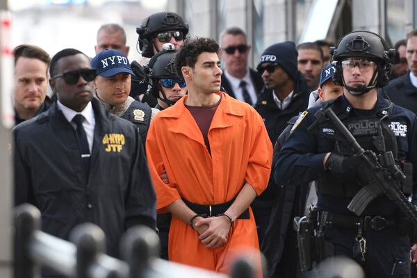 Luigi Mangione, a suspect in the fatal shooting of UnitedHealthcare CEO Brian Thompson, is escorted by police Thursday, Dec. 19, 2024, in New York. (AP Photo/Pamela Smith)