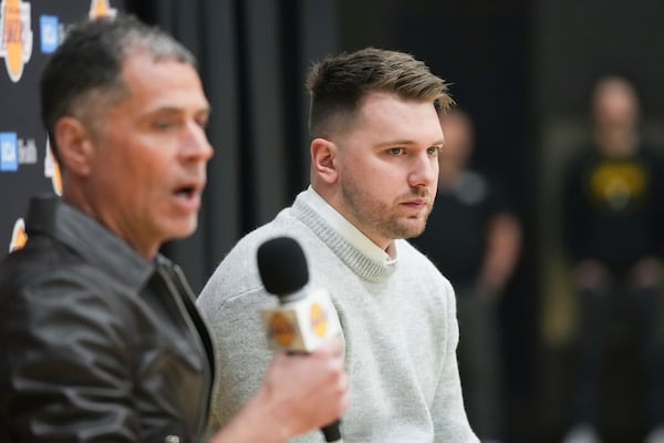 Los Angeles Lakers' Luka Doncic, right, and general manger Rob Pelinka field questions during an introductory NBA basketball press conference Tuesday, Feb. 4, 2025, in El Segundo, Calif. (AP Photo/Jae C. Hong)