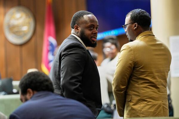 Former Memphis Police Officer Tedarrius Bean, center, one of three former Memphis officers charged with fatally beating Tyre Nichols in 2023, stands in the courtroom with his fellow defendants Justin Smith Jr., right, and Demetrius Haley, left, during break in the trial Wednesday, April 30, 2025, in Memphis, Tenn. (AP Photo/George Walker IV, Pool)