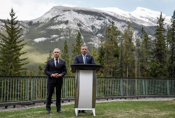 Ukraine Minister of Finance, Sergii Marchenko, right, and Canada's Finance Minister Francois-Philippe Champagne speak to the media prior to the G7 Finance Ministers meeting in Banff, Alberta, Tuesday, May 20, 2025. (Jeff McIntosh/The Canadian Press via AP)