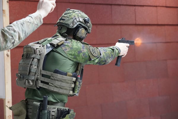 Members of the Vantaa Reservists Association practice at a shooting range in a warehouse in Kerava on the outskirts of Helsinki, Finland Monday, Dec. 2, 2024. (AP Photo/James Brooks)