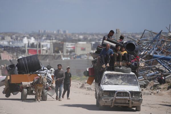 Displaced Palestinians, carrying their belongings traveling from Beit Hanoun to Jabaliya, a day after Israel's renewed offensive in the Gaza Strip, Wednesday, March 19, 2025. (AP Photo/Jehad Alshrafi)