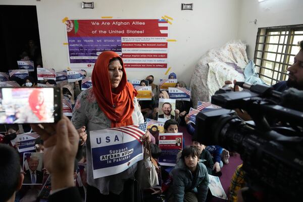 An Afghan refugee woman speaks with members of media prior to their meeting to discuss situation after President Donald Trump paused the U.S. refugee programs, in Islamabad, Pakistan, Friday, Jan. 24, 2025. (AP Photo/Anjum Naveed)