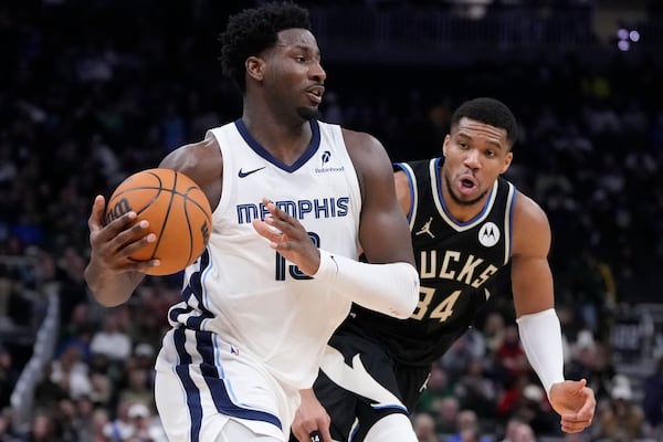 Memphis Grizzlies' Jaren Jackson Jr. drives past Milwaukee Bucks' Giannis Antetokounmpo during the second half of an NBA basketball game Sunday, Feb. 2, 2025, in Milwaukee. (AP Photo/Morry Gash)