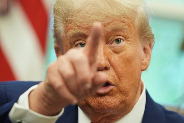President Donald Trump gestures as he speaks with reporters after announcing a trade deal with United Kingdom in the Oval Office of the White House, Thursday, May 8, 2025, in Washington. (AP Photo/Evan Vucci)