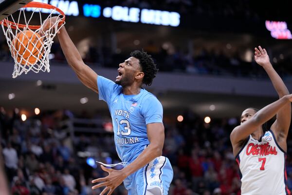 North Carolina forward Jalen Washington (13) dunks the ball against Mississippi guard Davon Barnes (7) during the second half in the first round of the NCAA college basketball tournament, Friday, March 21, 2025, in Milwaukee, Wis. (AP Photo/Kayla Wolf)