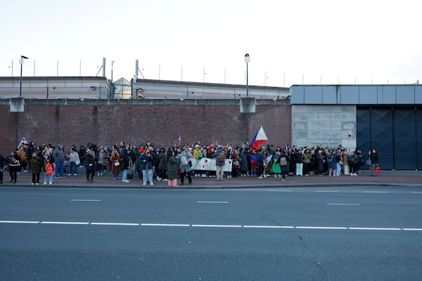 Supporters of former Philippine President Rodrigo Duterte hold flags and banners during a demonstration outside the International Criminal Court detention center near The Hague in Scheveningen, Netherlands, Wednesday, March 12, 2025. (AP Photo/Omar Havana)