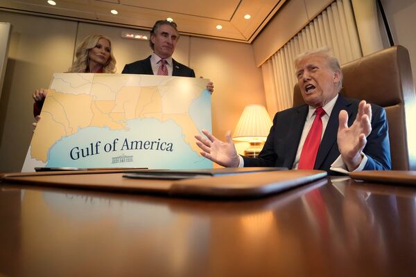 President Donald Trump, from right, speaks to reporters accompanied by Interior Secretary Doug Burgum and Burgum's wife Kathryn Burgum, aboard Air Force One where Trump signed a proclamation declaring Feb. 9 Gulf of America Day, as he travels from West Palm Beach, Fla. to New Orleans, Sunday, Feb. 9, 2025. (AP Photo/Ben Curtis)