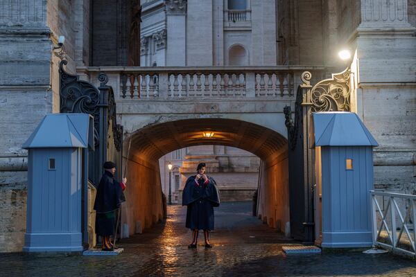 Pontifical Swiss Guards stand watch in St. Peter's Square at The Vatican, Monday, Feb. 24, 2025. (AP Photo/Bernat Armangue)