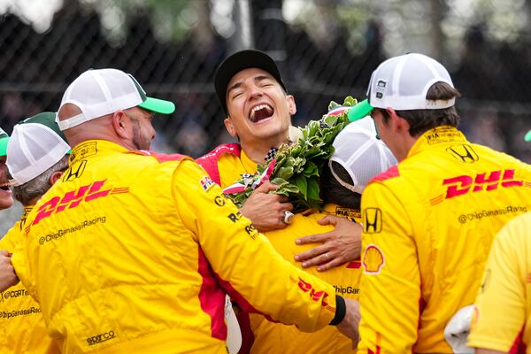 Alex Palou, center, of Spain, celebrates with his crew after winning the Indianapolis 500 auto race at Indianapolis Motor Speedway in Indianapolis, Sunday, May 25, 2025. (AP Photo/AJ Mast)