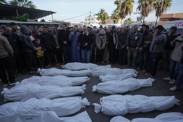 Mourners pray next to the bodies of Palestinians who were killed in the Israeli bombardment of the Gaza Strip at Al-Aqsa Hospital in Deir al-Balah, Wednesday, Jan. 15, 2025. (AP Photo/Abdel Kareem Hana)