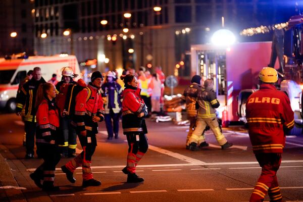 Emergency services work in a cordoned-off area near a Christmas Market, after a car drove into a crowd in Magdeburg, Germany, Friday, Dec. 20, 2024. (AP Photo/Ebrahim Noroozi)