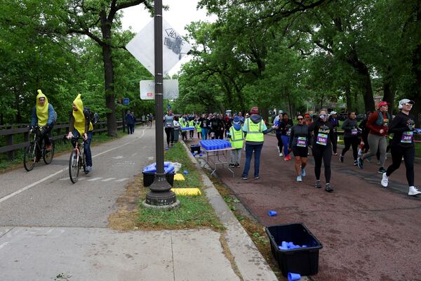 Runners get hydration via Hiccup, a reusable silicone cup, during the PNC Women Run the Cities race on Saturday, May 17, 2025, in Minneapolis. (AP Photo/Ellen Schmidt)