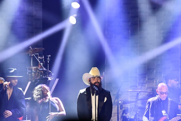 Post Malone, center, performs during the Pre-Grammy Gala on Saturday, Feb. 1, 2025, at the Beverly Hilton Hotel in Beverly Hills, Calif. (Photo by Richard Shotwell/Invision/AP)