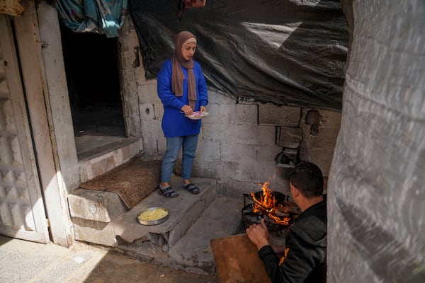 Rawya Tamboura and her husband Ahmed prepare a meal in their home, which was struck by an Israeli airstrike on Oct. 20, 2023, in Beit Lahiya, northern Gaza Strip, Friday, Feb. 21, 2025. (AP Photo/Abdel Kareem Hana)