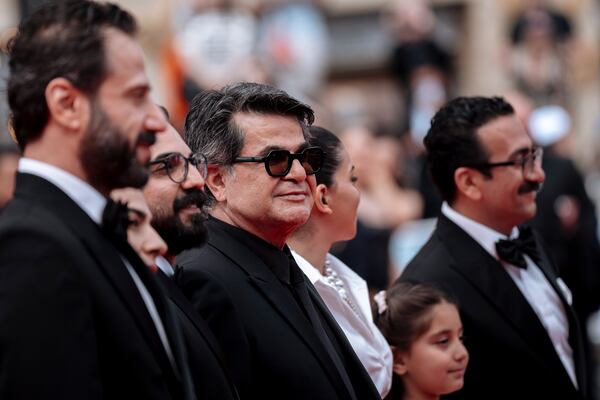 Director Jafer Panahi, centre, poses for photographers upon arrival at the premiere of the film 'It Was Just an Accident' at the 78th international film festival, Cannes, southern France, Tuesday, May 20, 2025. (Photo by Lewis Joly/Invision/AP)