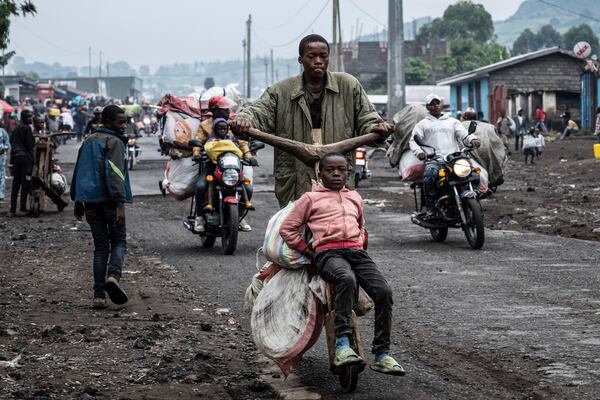 People displaced by the fighting with M23 rebels make their way to the center of Goma, Democratic Republic of the Congo, Sunday, Jan. 26, 2025. (AP Photo/Moses Sawasawa)