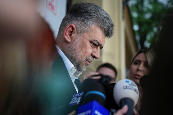 Romanian Prime Minister Marcel Ciolacu is surrounded by media at the PSD headquarters as he announces his resignation, in Bucharest, Romania, Monday, May 5, 2025, the day after the governing coalition's candidate failed to advance to the runoff in the presidential election rerun. (AP Photo/Andreea Alexandru)